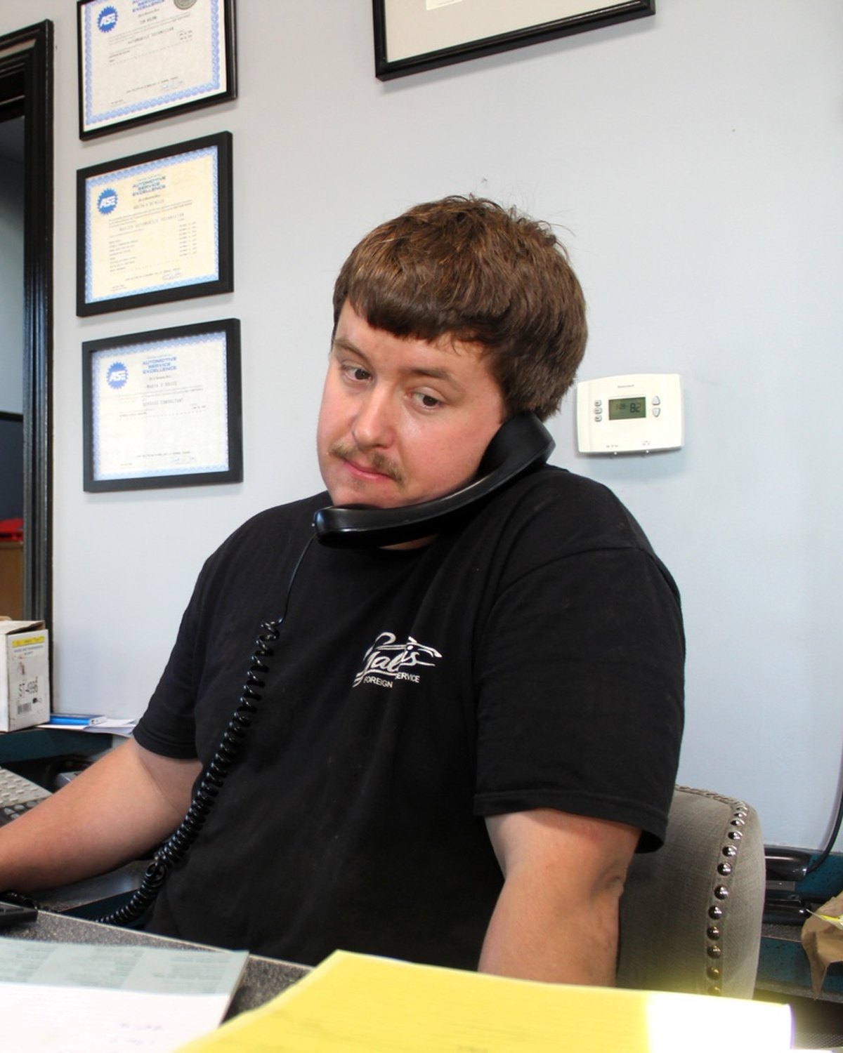 Austin Detwiler, owner and operator of Galati's Foreign Car Service, on the phone at the service desk