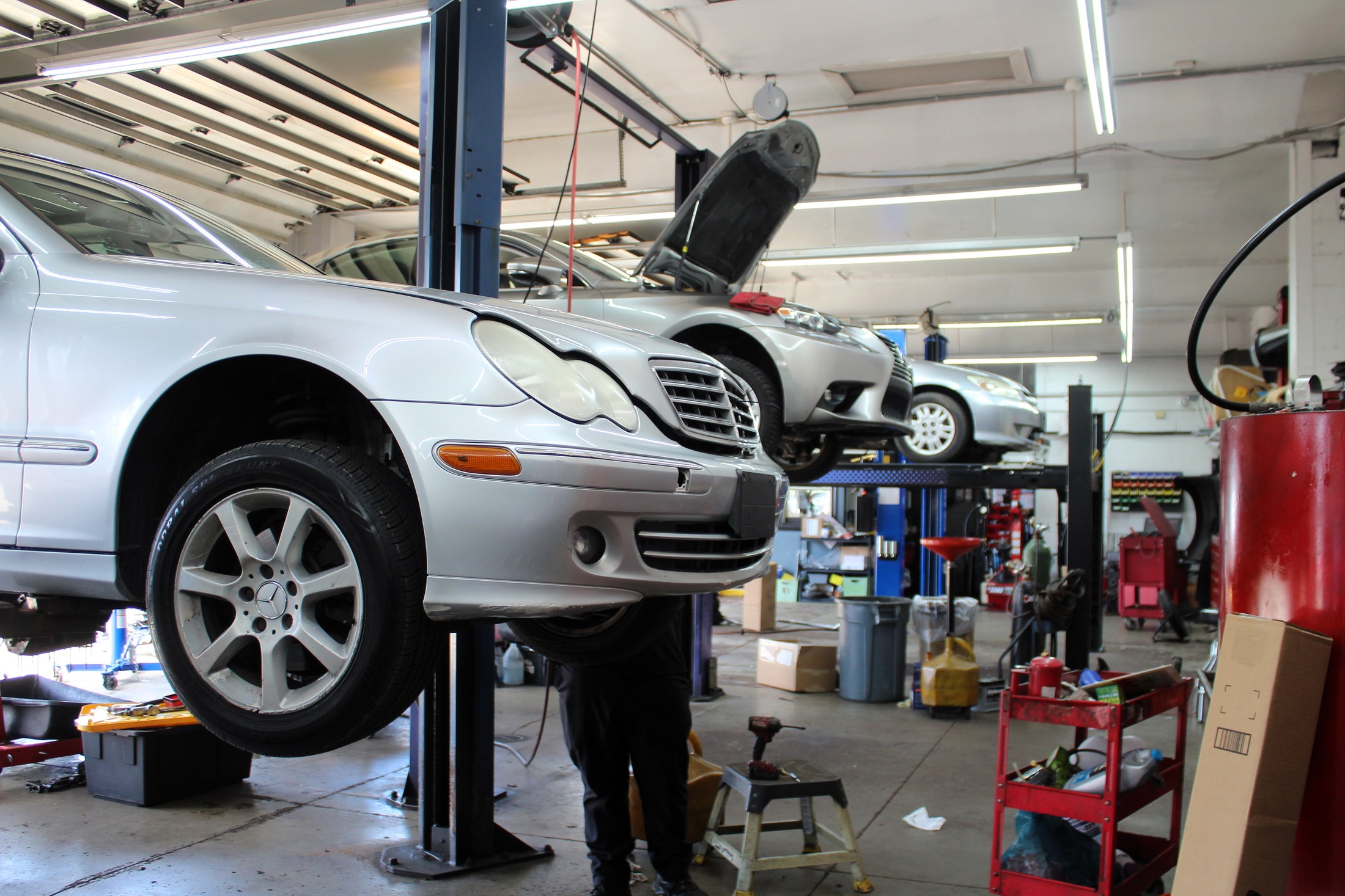 A European sedan on a service bay floor inside Galati's Foreign Car Service